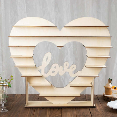 Wooden heart display with "love" cutout, perfect for events and decor.