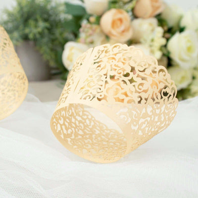 Decorative lace paper candle holder on soft fabric backdrop.