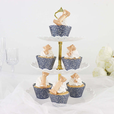 Elegant tiered cupcake stand with decorative cupcakes topped with swirls of cream.