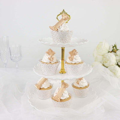 Elegant tiered cupcake stand with decorative cupcakes and whipped cream.