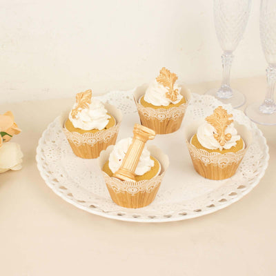 Decorative cupcakes with whipped cream on a lace plate.