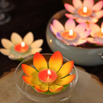 Colorful floating lotus candles in a decorative bowl.