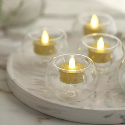 Decorative LED candles in glass holders on a round tray.