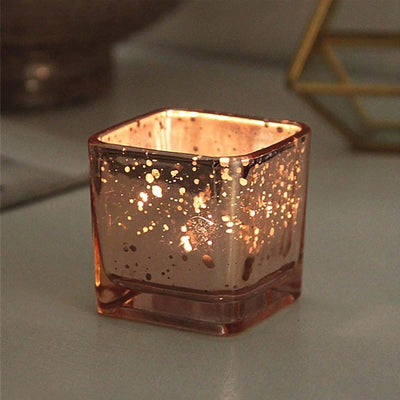 Decorative glass candle holder with glittering gold speckles.