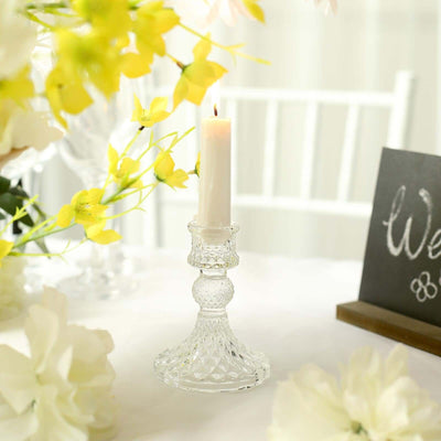 Crystal candle holder with white candle and floral decor