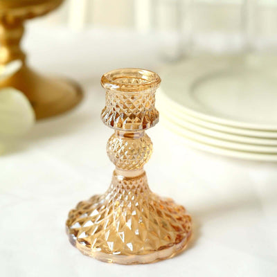 Vintage glass candlestick holder in soft amber hue.