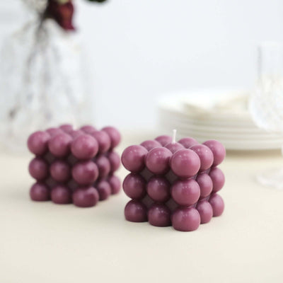 Purple bubble candle set on a neutral table setting.