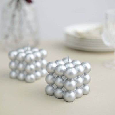 Silver bubble candle decor on a neutral background.