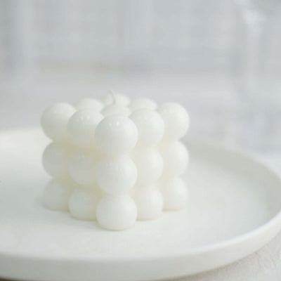 White bubble candle on a minimalist plate