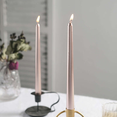 Elegant pink taper candles in stylish holders, glowing softly.