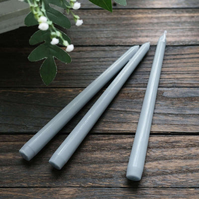 Gray taper candles in a studio-style isolation shot