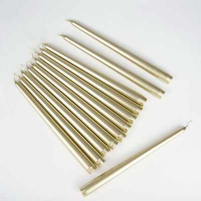 Gold taper candles arranged on a white background.