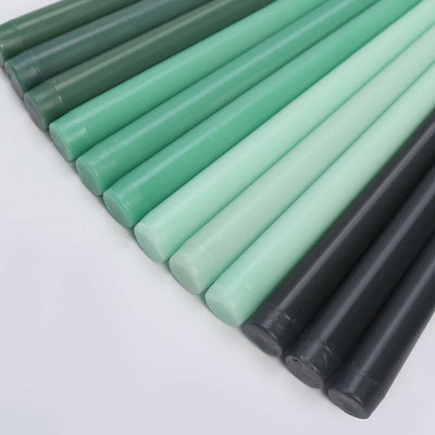 Colorful wax sticks in green and black arranged in a row.