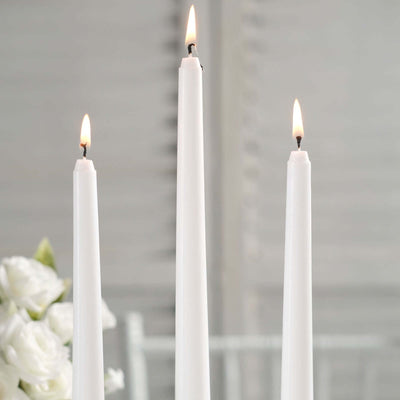 Three elegant white candles burning softly.