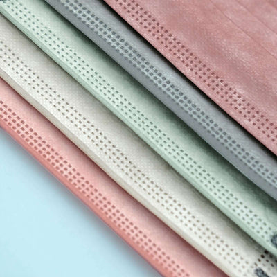 Colorful textured sheets in shades of pink, green, gray, and white.
