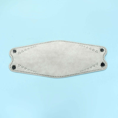 Decorative fabric mask with heart patterns and stitching details.