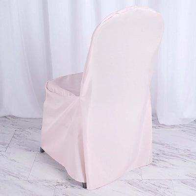 Pink chair cover draped over a chair, showcasing its design and fit.