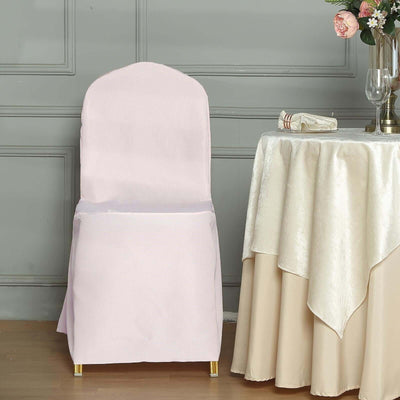 Pink chair cover draped over a chair in an elegant setting.