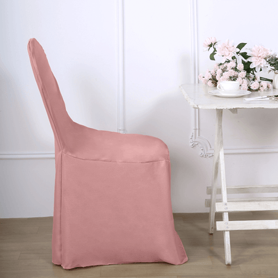 Pink chair cover on a dining chair beside a table with flowers and tea.