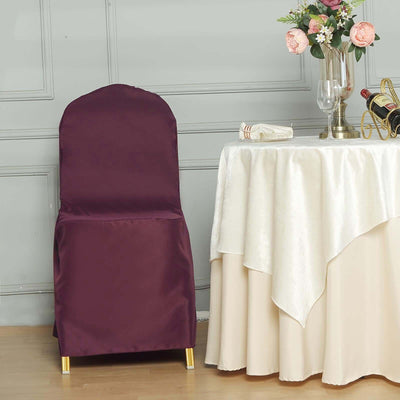 Elegant burgundy chair cover beside a beautifully set table.