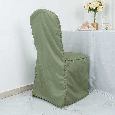 Green chair cover on a dining chair near a table with flowers.