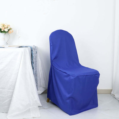 Blue chair cover on a chair beside a table with floral centerpiece.