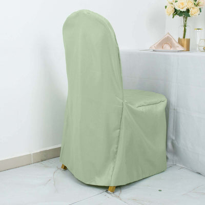 Green chair cover draped over a dining chair in a styled setting.