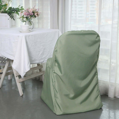 Green chair cover draped over a chair in a bright, airy dining room setting.