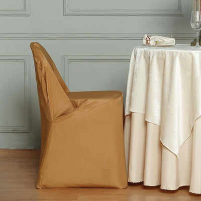 Modern gold chair beside a table with a tablecloth.