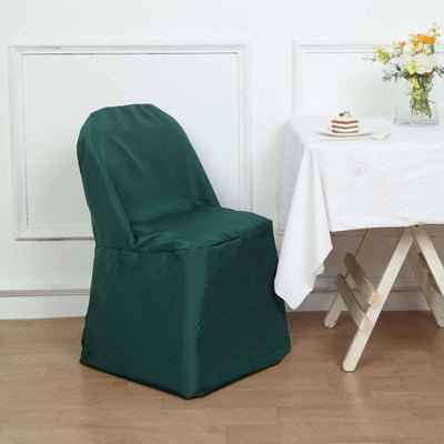 Green chair cover on a dining chair next to a table with flowers and dessert.
