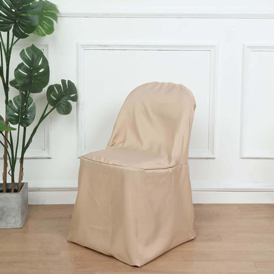 Beige chair cover on a simple chair with a plant in the background.