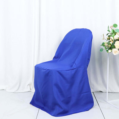 Blue chair cover draped over a chair in a studio setting.