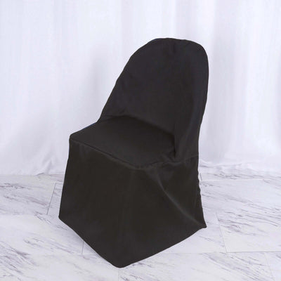 Black chair cover draped over a dining chair on a light background.