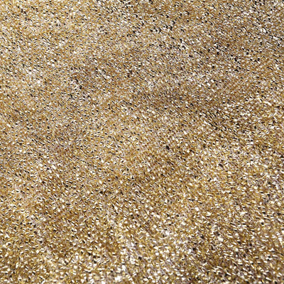 Close-up of textured gold fabric with shimmering details.