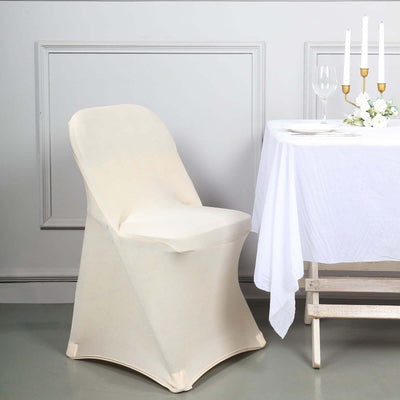 Elegant cream chair cover draped on a chair beside a table setting.