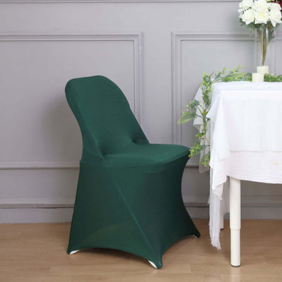 Green chair cover on a modern chair beside a table with a floral arrangement.