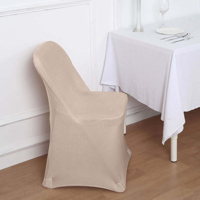 Beige chair cover draped over a chair beside a dining table.