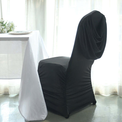 Black chair cover draped elegantly over a chair at a dining table.