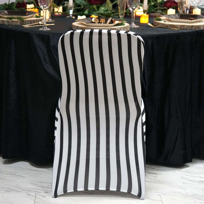 Black and white striped chair against a dark table setting.