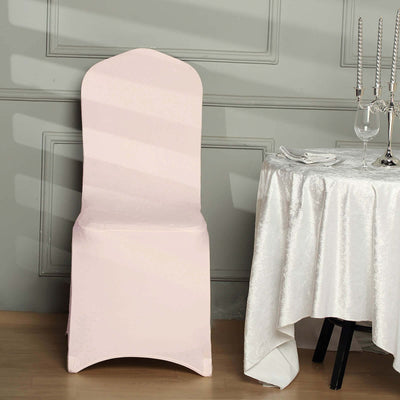 Elegant pink chair cover on a dining chair with a table setting.