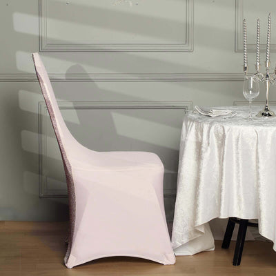 Elegant pink chair cover draped on a chair next to a dining table.