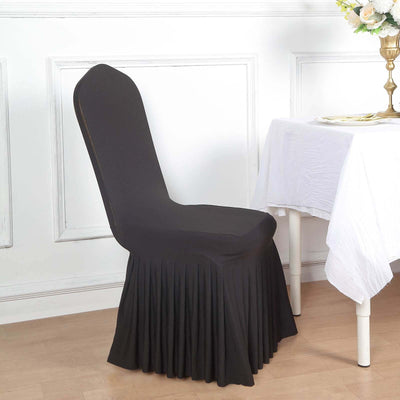 Black stretch chair cover with pleated skirt for elegant dining settings.