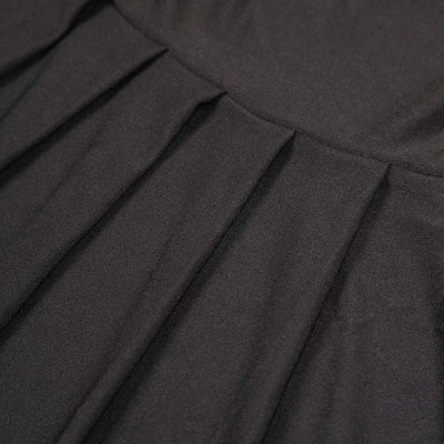 Close-up of black fabric texture with pleats.