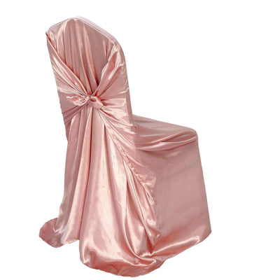 Pink satin chair cover with bow detail, perfect for events and weddings.
