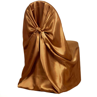 Gold satin chair cover with elegant bow detail on a plain backdrop.
