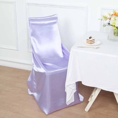 Purple satin chair cover draped elegantly over a chair beside a table.