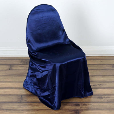 Navy blue satin chair cover on a wooden floor.