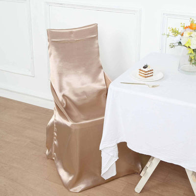 Gold satin chair cover elegantly draped over a chair beside a white table.