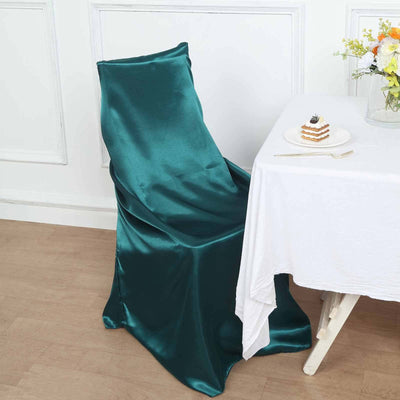 Teal satin chair cover draped elegantly over a chair.