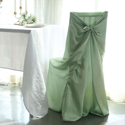 Elegant mint green chair cover draped elegantly at a dining table.